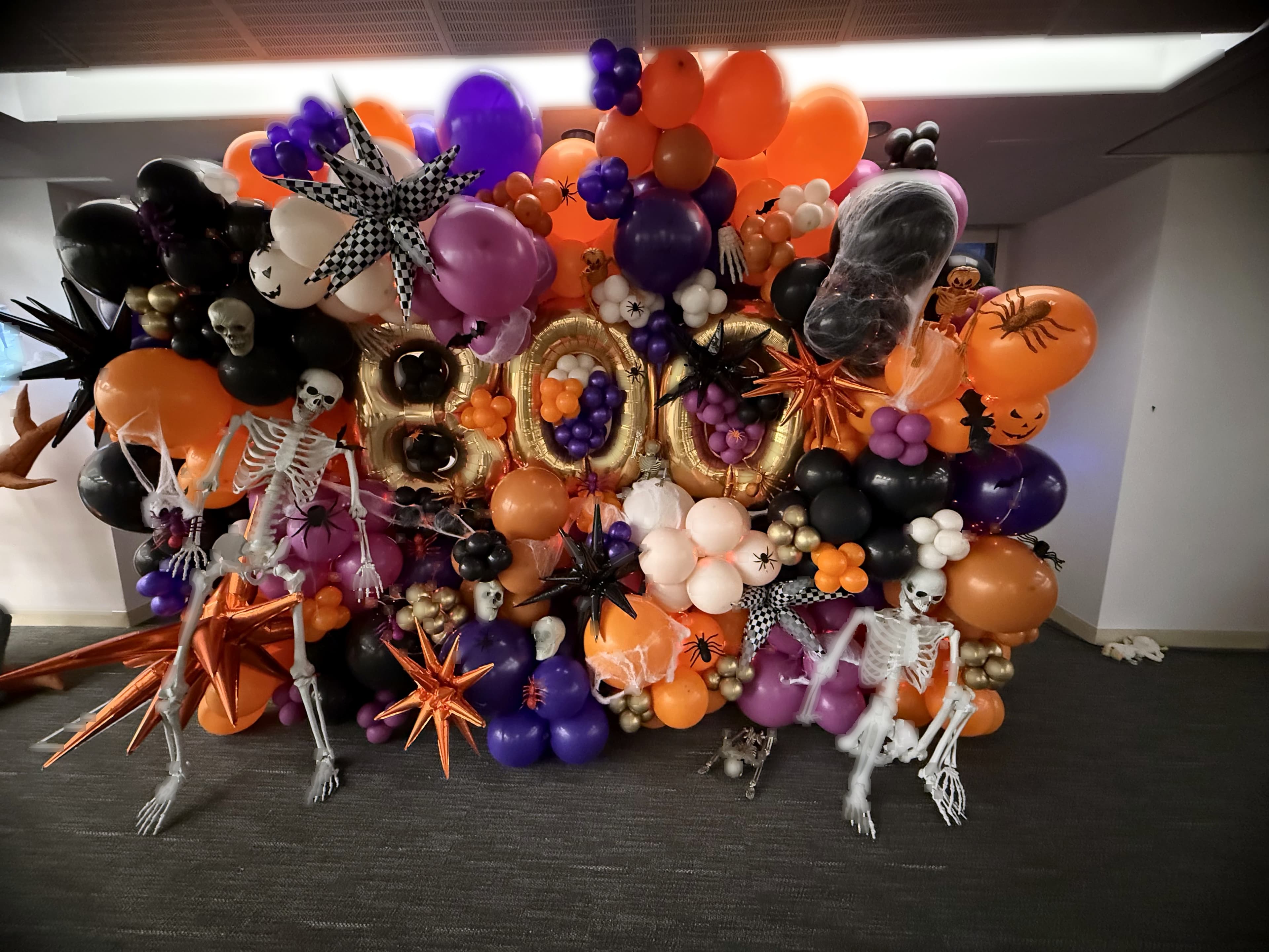 Halloween BOO letter balloon wall with orange, black and purple styling for a corporate event