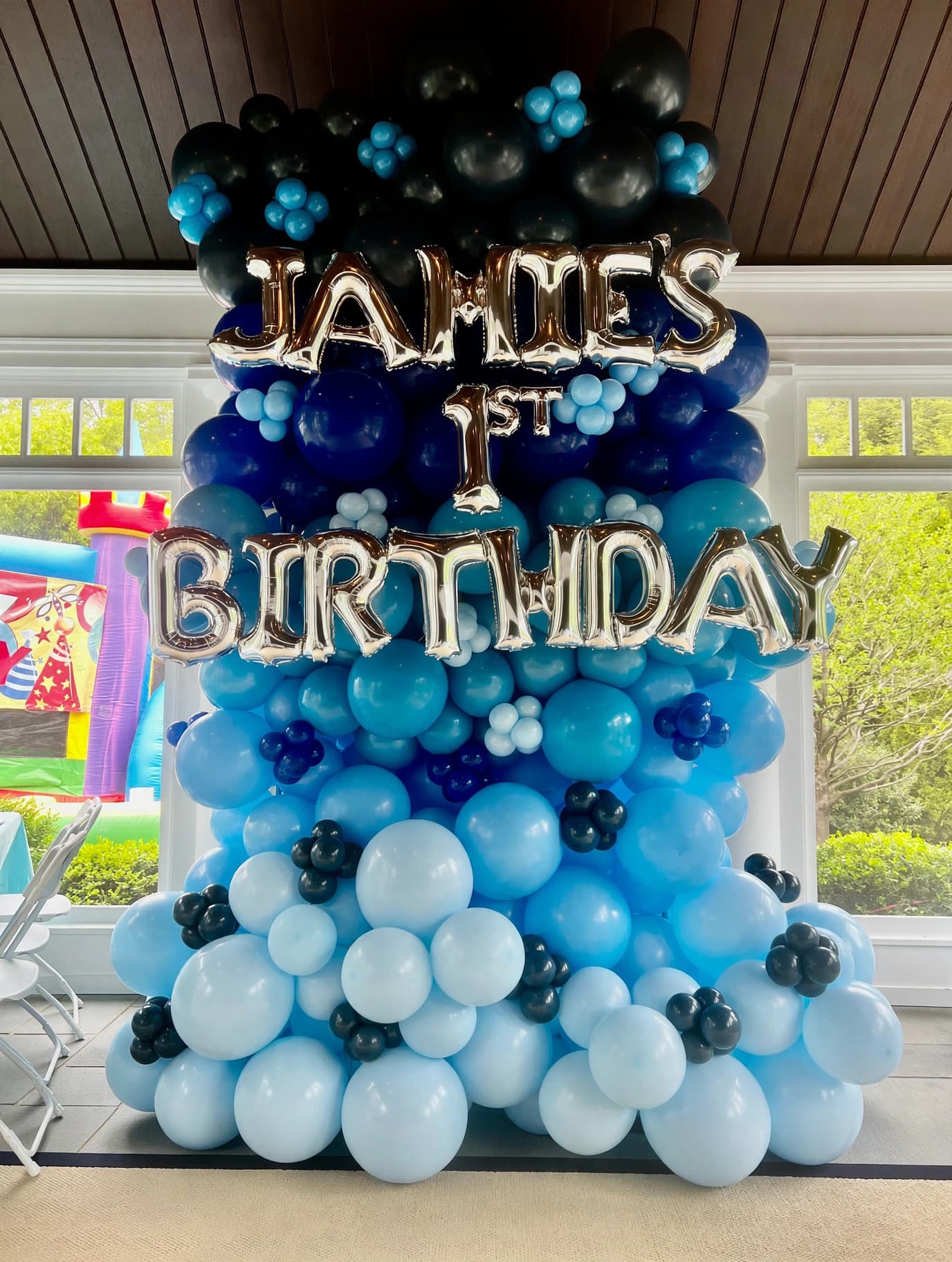 Blue and white balloon wall for Jahdes first birthday celebration