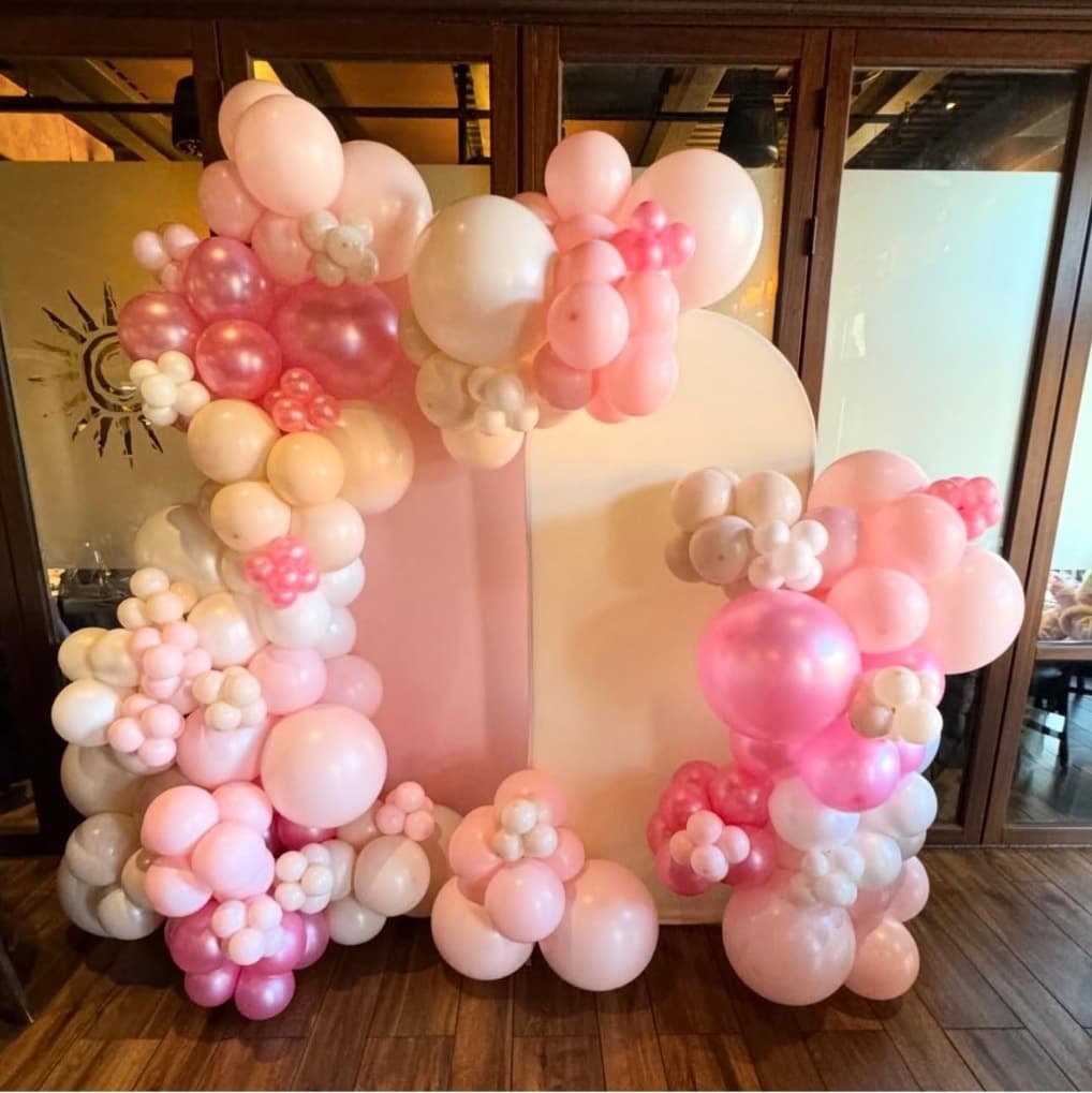 Pink and white organic garlands framing blush and cream arch backdrops