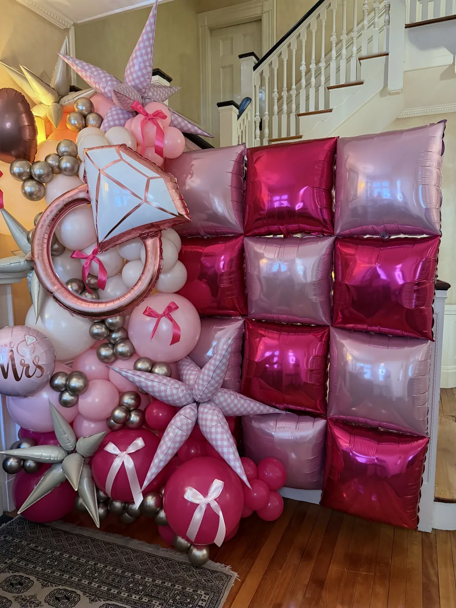 Blush pink showstopper garland with a ring balloon and Mrs sign for an engagement celebration